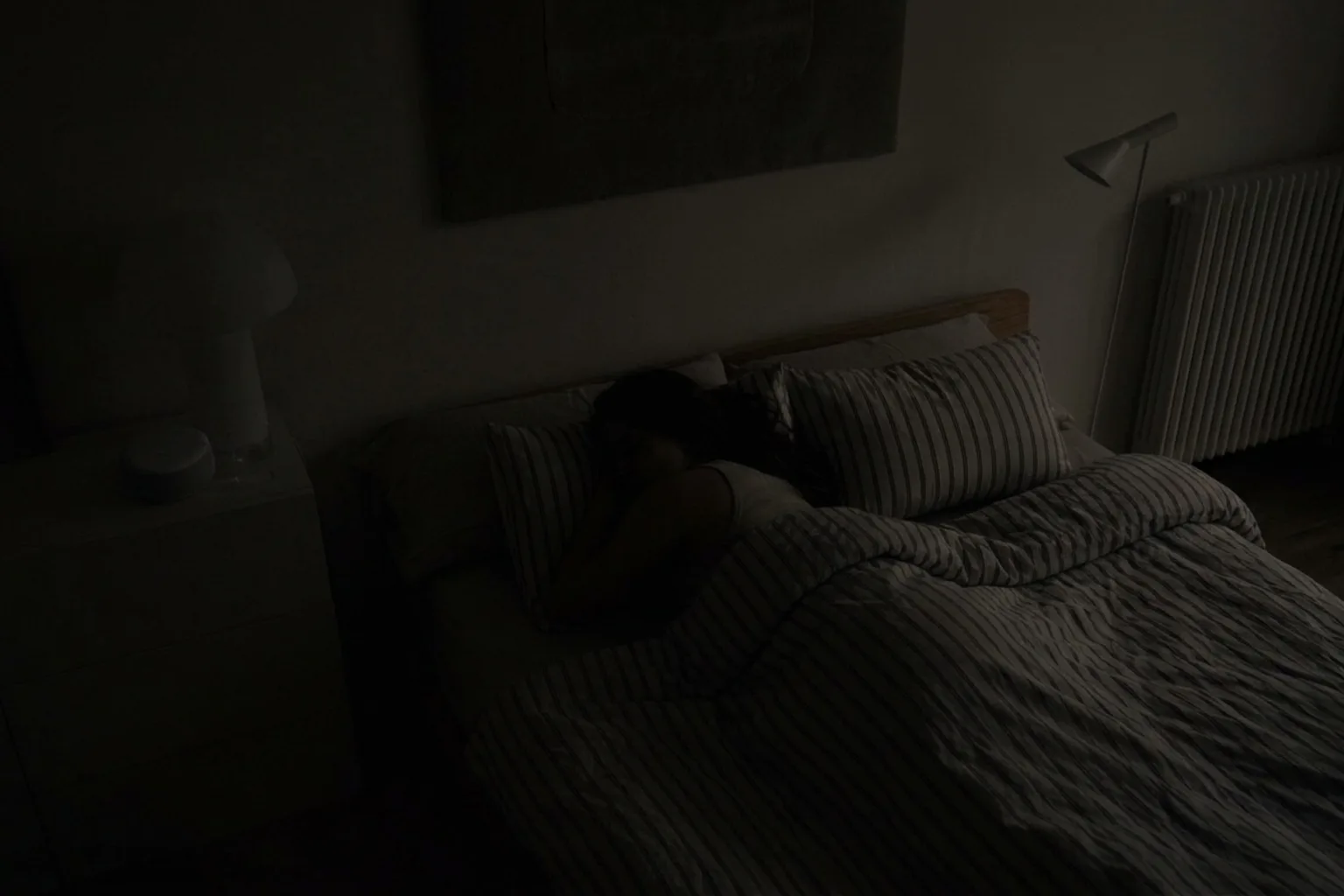 A darkened bedroom at night with the Wove sensor glowing faintly.